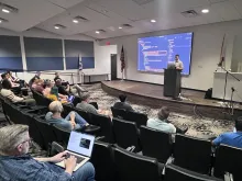 Balint presenting in the auditorium