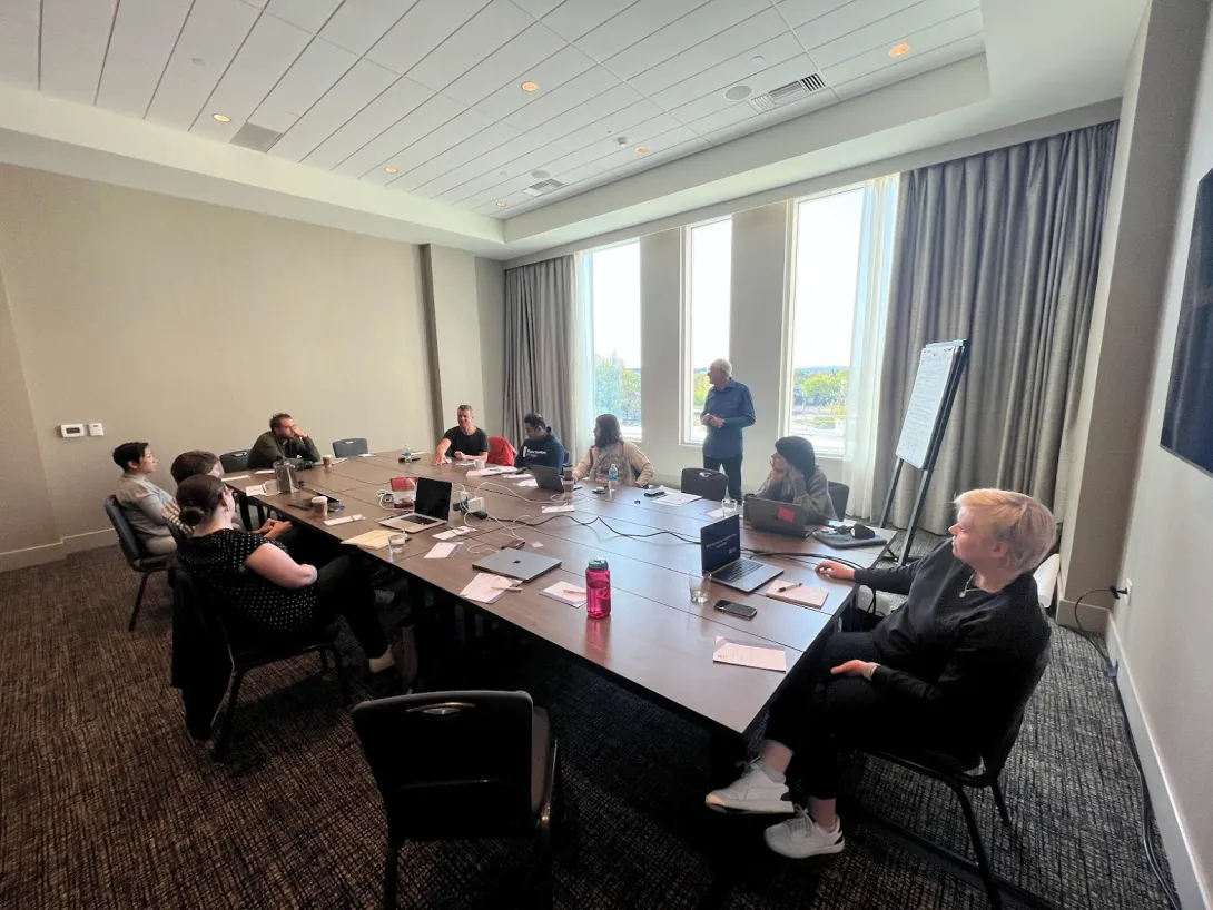 DA board members around a table in a meeting room