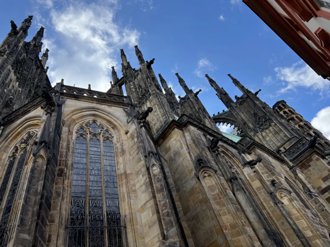 Looking up at St Vites cathedral with a blue sky as a background