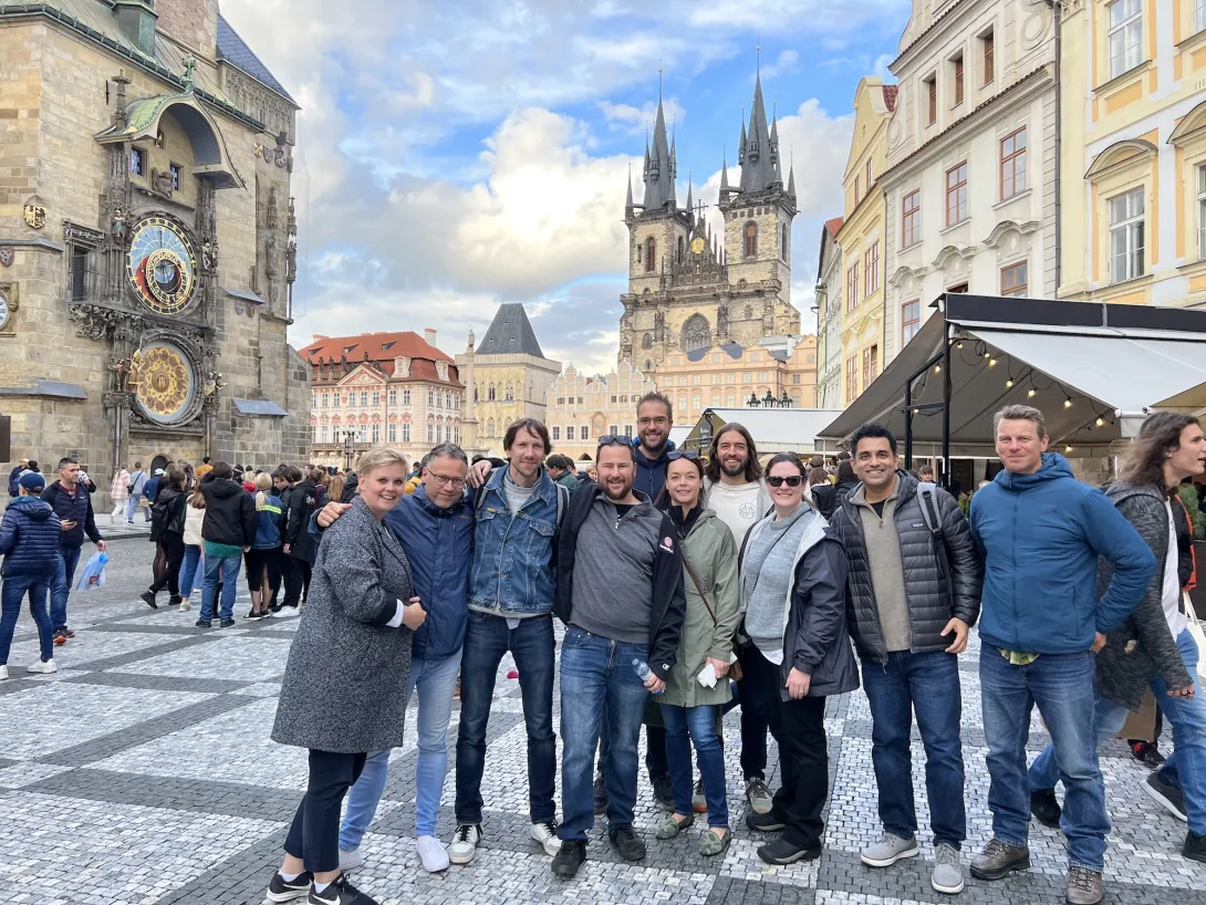 Photo of the DA board of directors in downtown Prague in front of the astronomy clock and some castle