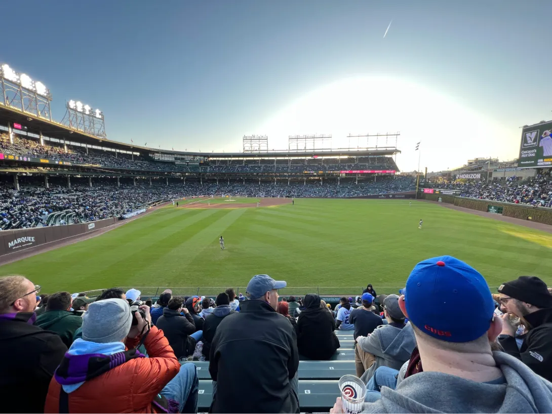 View of Wrigley Field during sunset showing a large green field and stands