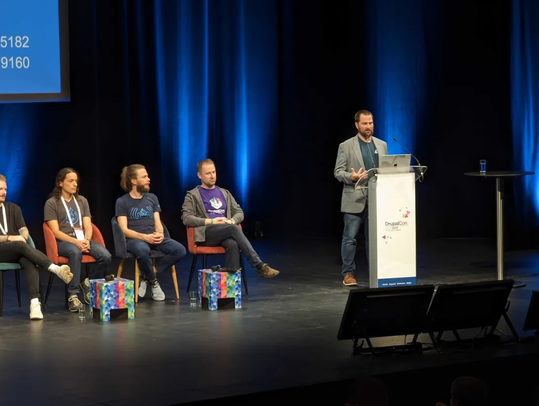 Me presenting in front of podium on large stage