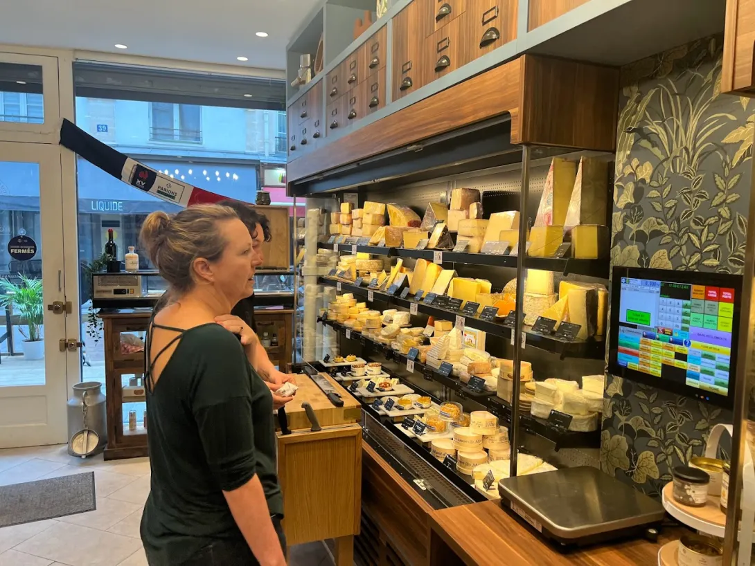 Robin evaluating all the choices in a cheese store