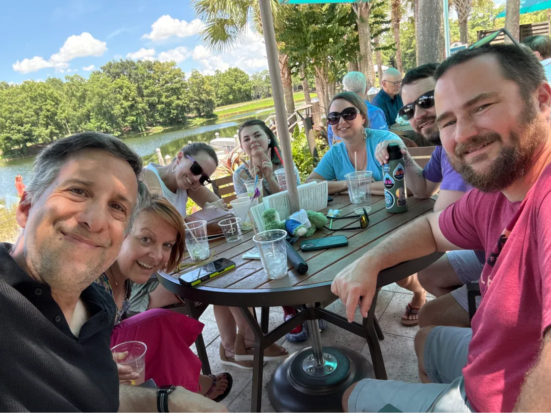 Part of the local DrupalCamp Orlando planning team sitting around a table at a resort